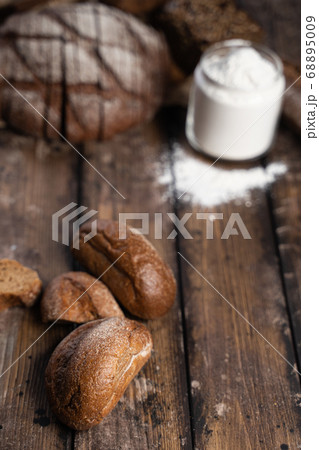 Rye buns and flour on table 68895009