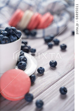 Fresh blueberries and macaroon on table Fresh blueberries and macaroon on table 68895011