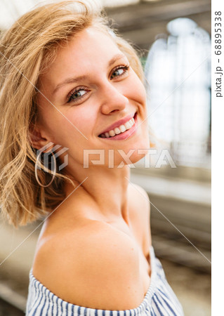 Portrait of smiling blonde woman standing in Portrait of smiling blonde woman standing in 68895338