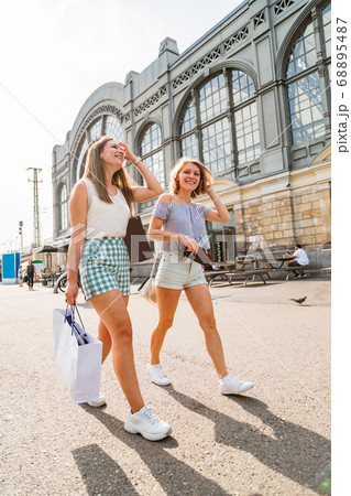 Two young girls walking on a sunny day 68895487