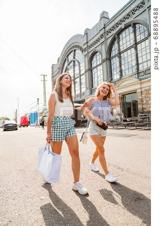 Two young girls walking on a sunny day 68895488