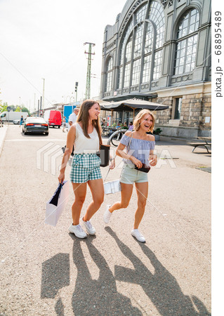 Two young girls walking on a sunny day 68895489