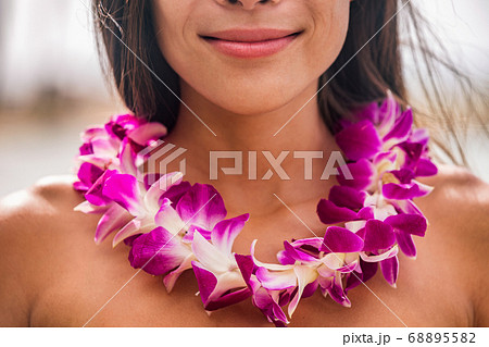 Lei hawaii welcome necklace of fresh orchids flowers garland on woman's neck. Aloha spirit. Hula dancer at luau beach party Lei hawaii welcome necklace of fresh orchids flowers garland on woman's neck. Aloha spirit. Hula dancer at luau beach party 68895582