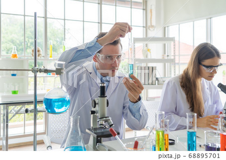 A western scientists couple working on test tube A western scientists couple working on test tube 68895701