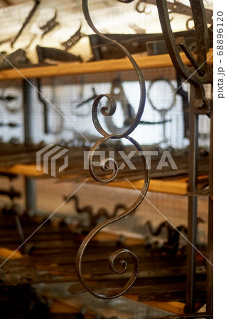 A shop or a museum of blacksmithing.The key hung on the wall. The forged curl. A shop or a museum of blacksmithing.The key hung on the wall. The forged curl. 68896120