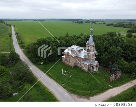 an old building with grass and trees,aerial photo 68898258