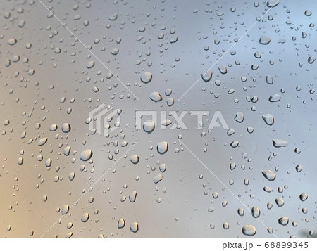Water droplets on the glass with a background Water droplets on the glass with a background 68899345