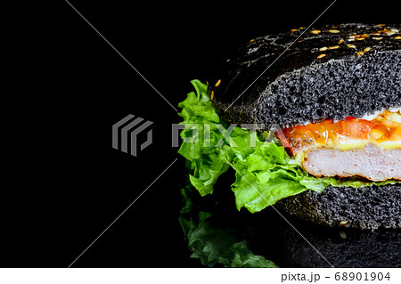 black hamburger close up on a black background  68901904