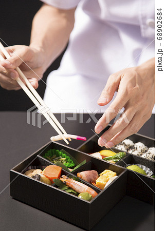 懐石弁当の盛り付けをする手元 68902684
