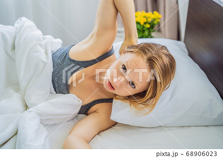 Upset young woman lying in bed in morning feels pain in neck after night sleep, awaken having painful sudden ache or stiffness, incorrect posture during sleep. Fibromyalgia concept Upset young woman lying in bed in morning feels pain in neck after night sleep, awaken having painful sudden ache or stiffness, incorrect posture during sleep. Fibromyalgia concept 68906023