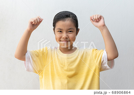 Asian girl standing make winner gesture. 68906864