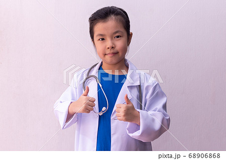 Asian girl playing doctor with stethoscope in Asian girl playing doctor with stethoscope in 68906868