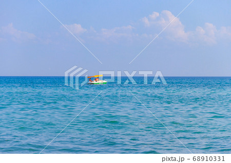 Young couple on a pedalo boat in the Black sea Young couple on a pedalo boat in the Black sea 68910331