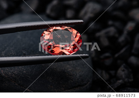 Oval red garnet gemstone with dark rock. Oval red garnet gemstone with dark rock. 68911573