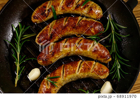 Fried sausages with rosemary, garlic and spices 68911970