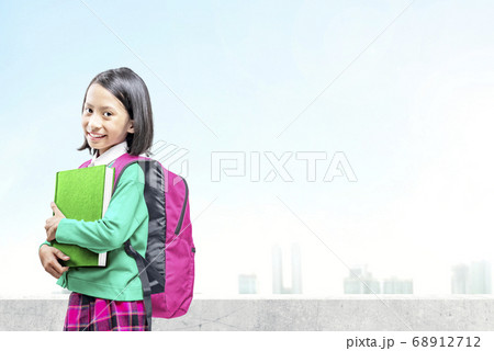 Asian little girl with book and backpack going to the school Asian little girl with book and backpack going to the school 68912712