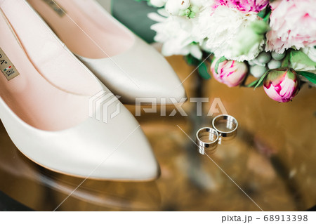 Beautiful toned picture with wedding rings and wedding shoes 68913398