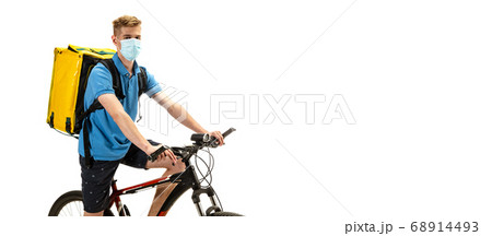 Deliveryman isolated on white studio background. Contacless delivery service during quarantine. 68914493