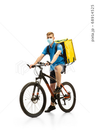 Deliveryman isolated on white studio background. Contacless delivery service during quarantine. Deliveryman isolated on white studio background. Contacless delivery service during quarantine. 68914525
