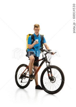 Deliveryman isolated on white studio background. Contacless delivery service during quarantine. 68914530