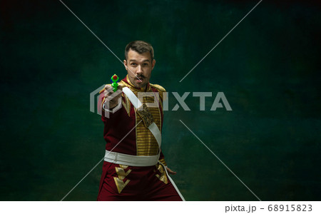 Young man as Nicholas II on dark green background. Retro style, comparison of eras concept. 68915823