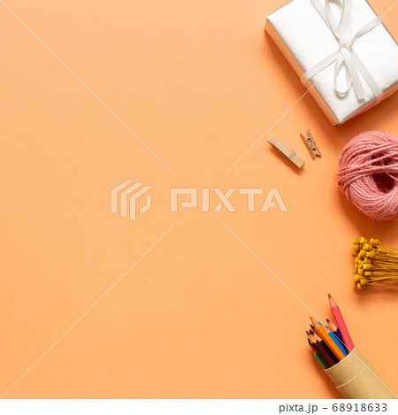 Gift box, string roll, colored pencil on orange background. flat lay, top view, copy space Gift box, string roll, colored pencil on orange background. flat lay, top view, copy space 68918633