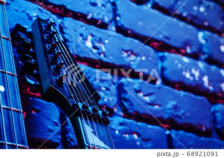 Guitar headstock with tuners on dark background Guitar headstock with tuners on dark background 68921091