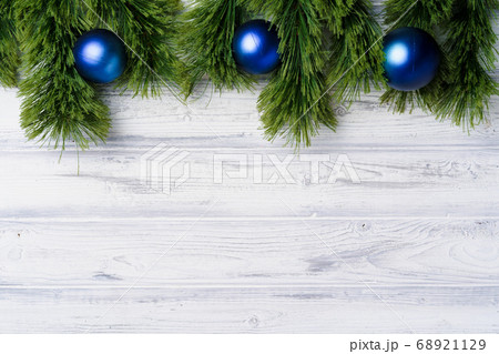 Christmas tree branches on white wooden background Christmas tree branches on white wooden background 68921129