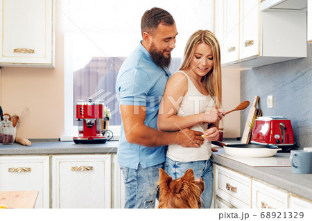Young loving couple cooking together in kitchen 68921329