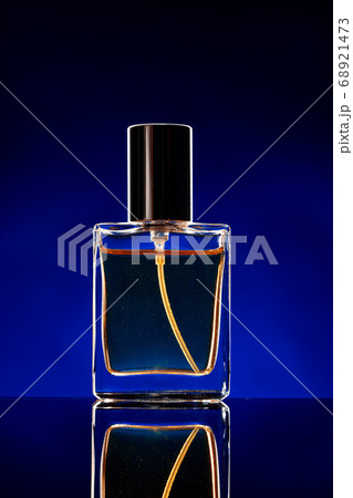 Glass bottle with cosmetic oil on dark background Glass bottle with cosmetic oil on dark background 68921473