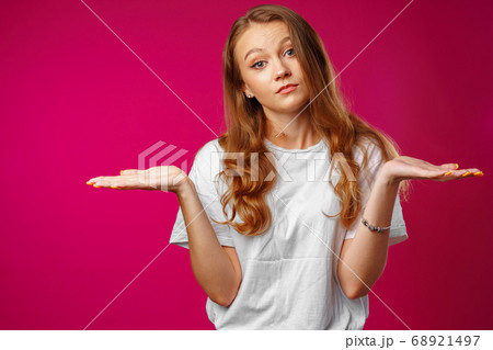 Young caucasian girl making do not know sign Young caucasian girl making do not know sign 68921497