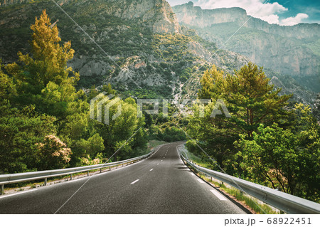 Beautiful Empty Asphalt Freeway, Motorway, Highway Against Mountains Background. Travel Road Concept. France Beautiful Empty Asphalt Freeway, Motorway, Highway Against Mountains Background. Travel Road Concept. France 68922451