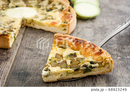 French quiche Lorraine with vegetables on a rustic wooden table	 68923249