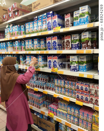 SEREMBAN, MALAYSIA -JULY 5, 2019: Processed and fresh milk packed in the paper box and displayed on the rack inside the supermarkets. Sorted by brand and type for easy for the customer to choose. SEREMBAN, MALAYSIA -JULY 5, 2019: Processed and fresh milk packed in the paper box and displayed on the rack inside the supermarkets. Sorted by brand and type for easy for the customer to choose. 68924269