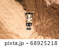 Bulldozer pushing large amount of fresh soil, Aerial shot. 68925218