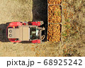 Forklift loading pallets of fresh picked Carrots onto a trailer 68925242