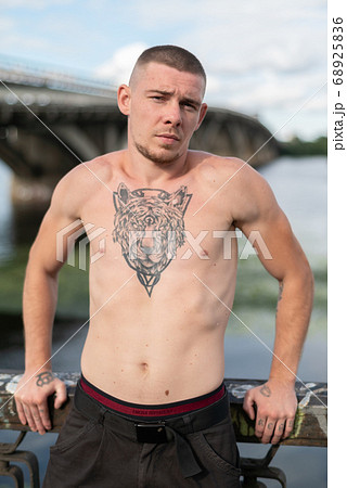 Male bully with a naked torso by day Male bully with a naked torso by day 68925836