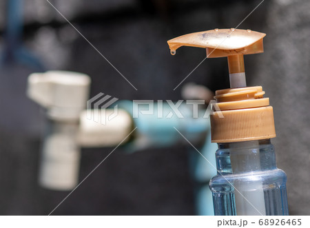 A tap and dishwashing detergent at outdoors A tap and dishwashing detergent at outdoors 68926465