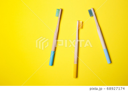 bright toothbrushes on a yellow background 68927174