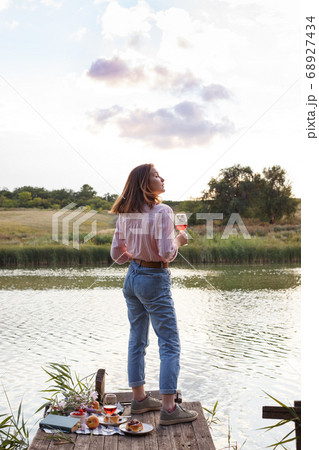 girl enjoying picnic on a wooden pie 68927434