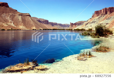 Band-e Amir lakes near Bamyan (Bamiyan) in Central Afghanistan. Band e Amir was the first national park in Afghanistan. View with reeds from the shore of a natural blue lake at Band e Amir Afghanistan Band-e Amir lakes near Bamyan (Bamiyan) in Central Afghanistan. Band e Amir was the first national park in Afghanistan. View with reeds from the shore of a natural blue lake at Band e Amir Afghanistan 68927556