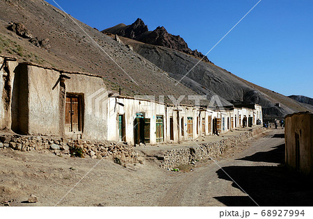 The main street of Syadara (Siyah Darah) in Bamyan (Bamiyan) Province, Afghanistan. Dirt road with houses in a village in Central Afghanistan. Syadara is a small, remote Afghan town in the mountains. The main street of Syadara (Siyah Darah) in Bamyan (Bamiyan) Province, Afghanistan. Dirt road with houses in a village in Central Afghanistan. Syadara is a small, remote Afghan town in the mountains. 68927994