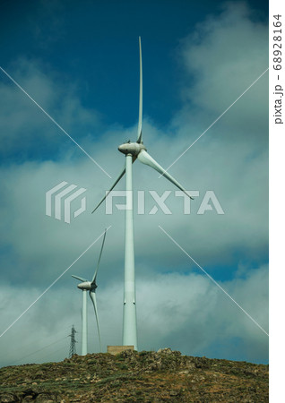 Wind turbines for electric power generation over hilly landscape 68928164