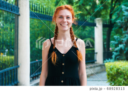 Cute ginger girl with expressive face outdoor. 68928313