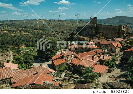 Old houses and castle on top of rocky cliff 68928326