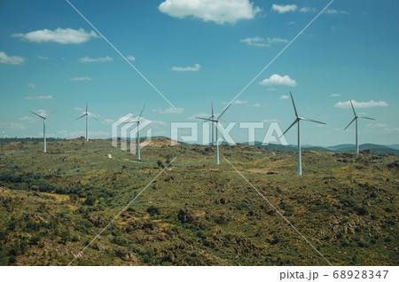 Several wind turbines over hilly landscape 68928347