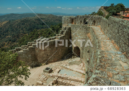 Pathway on stone wall with the front gate of Castle Pathway on stone wall with the front gate of Castle 68928363