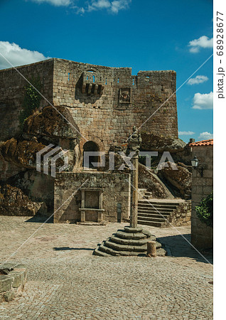 Castle facade over rocky hill on square 68928677