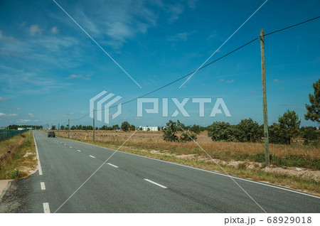 Car passing through countryside road Car passing through countryside road 68929018