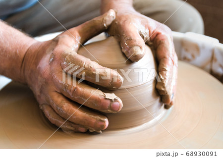 Male hands at pottery work. Male hands at pottery work. 68930091